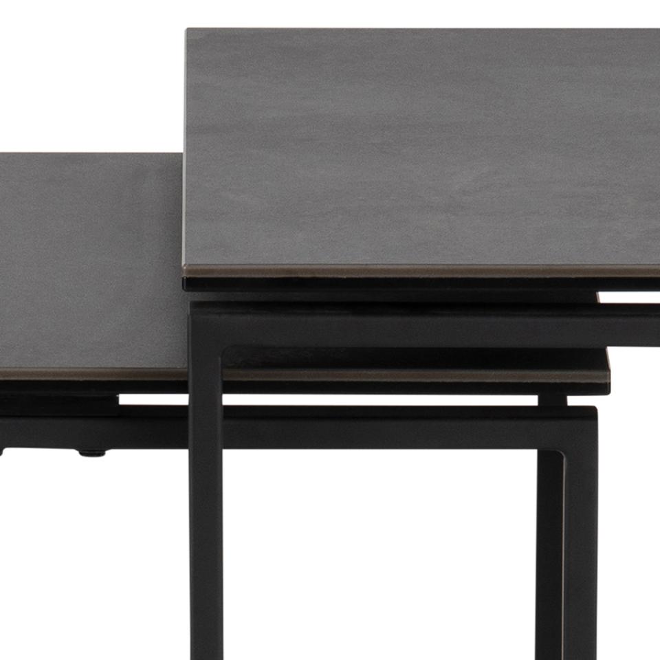 Two dark gray tables with black metal legs on a white background