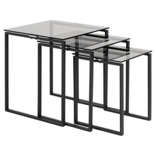 Load image into Gallery viewer, Set of three nesting tables with black metal frames and clear glass tops on a white background

