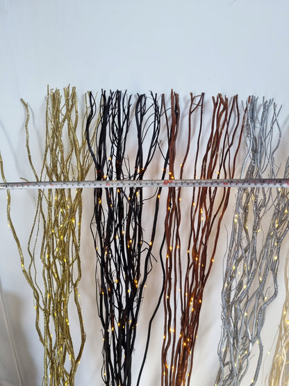 willow twigs with a tape measure across the width on a white background