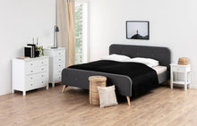 Load image into Gallery viewer, Modern bedroom with a gray bed, white nightstands, and a lamp.
