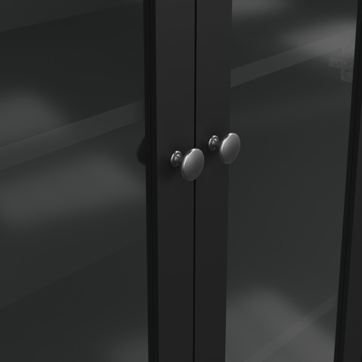 Close-up of two glass cabinet doors with round silver knobs, shown against a dark interior background.