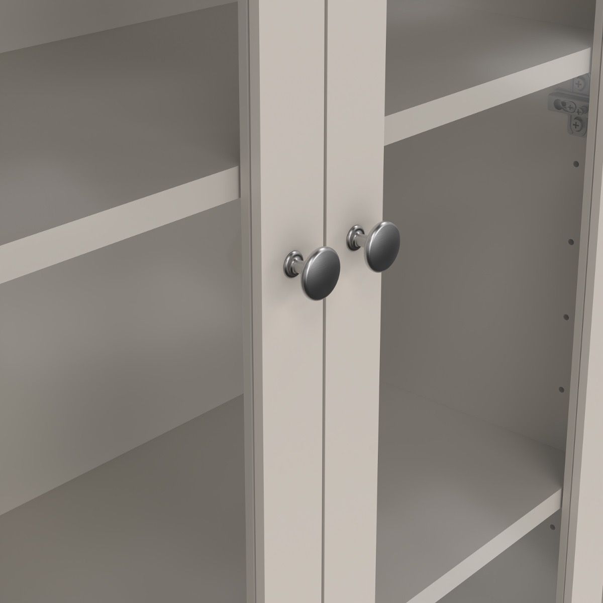 close up view of a greige cabinet with two glass doors and two metal hanles