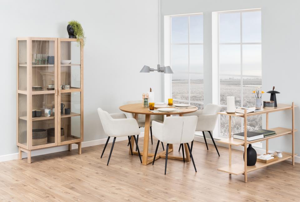 Dining room with wooden furniture including a bookshelf, table, and shelves.