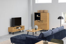 Load image into Gallery viewer, A modern living room setup featuring a dark blue tufted sectional sofa, a light oak wood TV stand, a matching tall cabinet, and a low wooden coffee table.
