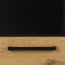Load image into Gallery viewer, Close-up of a black horizontal drawer handle mounted on a light oak wood cabinet door with a black upper panel.
