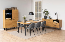 Load image into Gallery viewer, A modern dining room furniture set featuring a light oak wood dining table, six gray upholstered chairs, a matching tall side cabinet, and a long sideboard with drawers, all arranged on a light beige rug over a wood floor.
