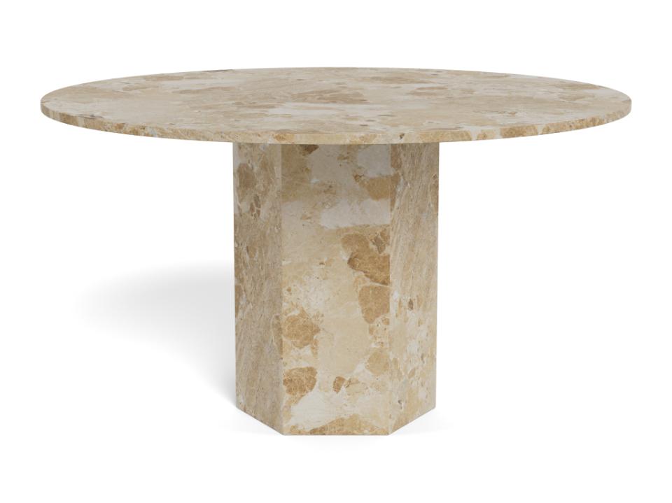 Round stone dining table on a white background