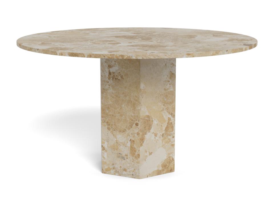 A round dining table made of beige and cream travertine stone, featuring a thick pedestal base and a polished top surface, shown on a white background.