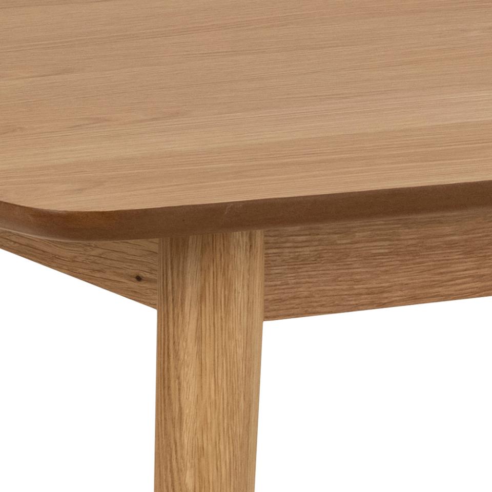 Close-up of a wooden table with a white background
