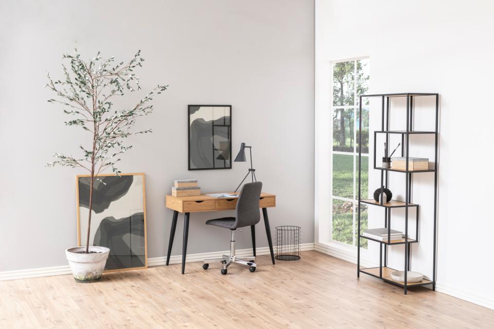Modern home office with desk, chair, and decorative elements.