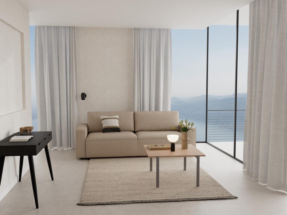 Modern living room with a beige sofa, coffee table, and decorative items.