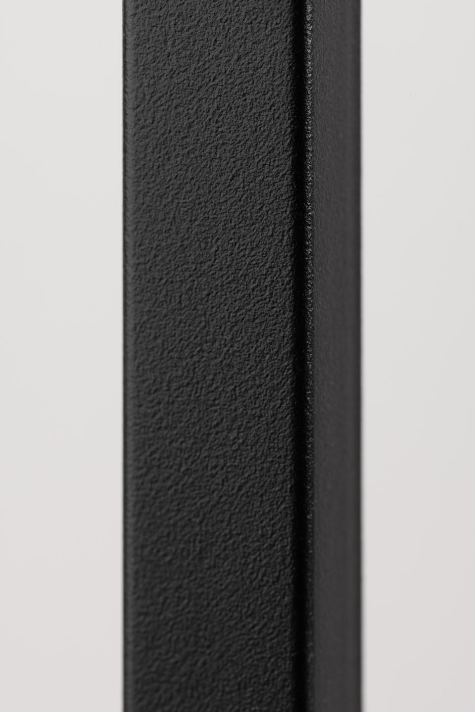 Close-up of a textured black strip on a light gray background