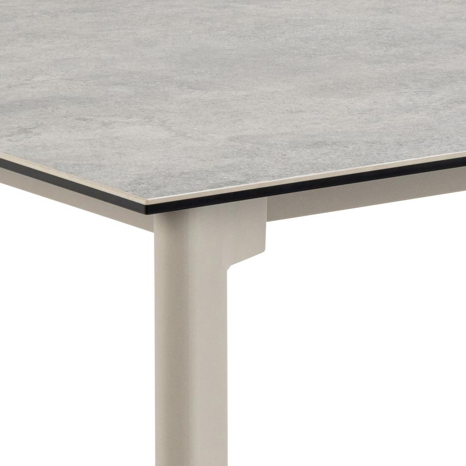 Table with a gray textured ceramic top and grey legs on a white background