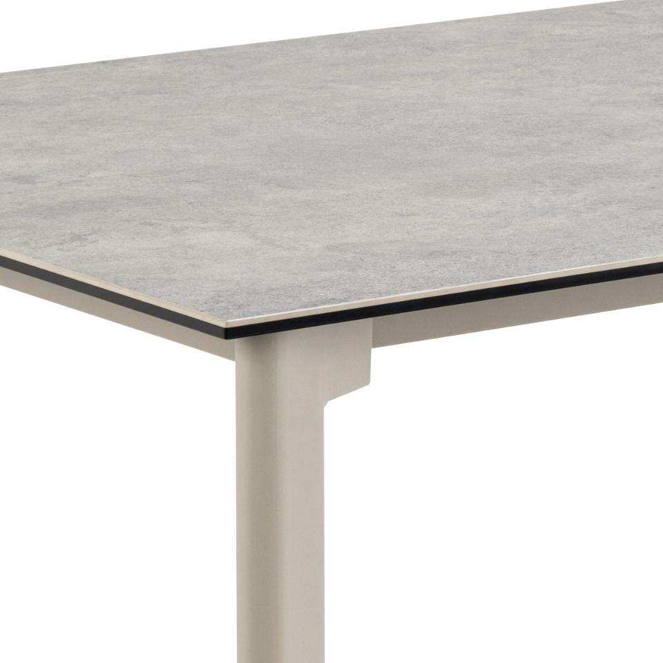 Table with a grey ceramic surface and grey legs on a white background