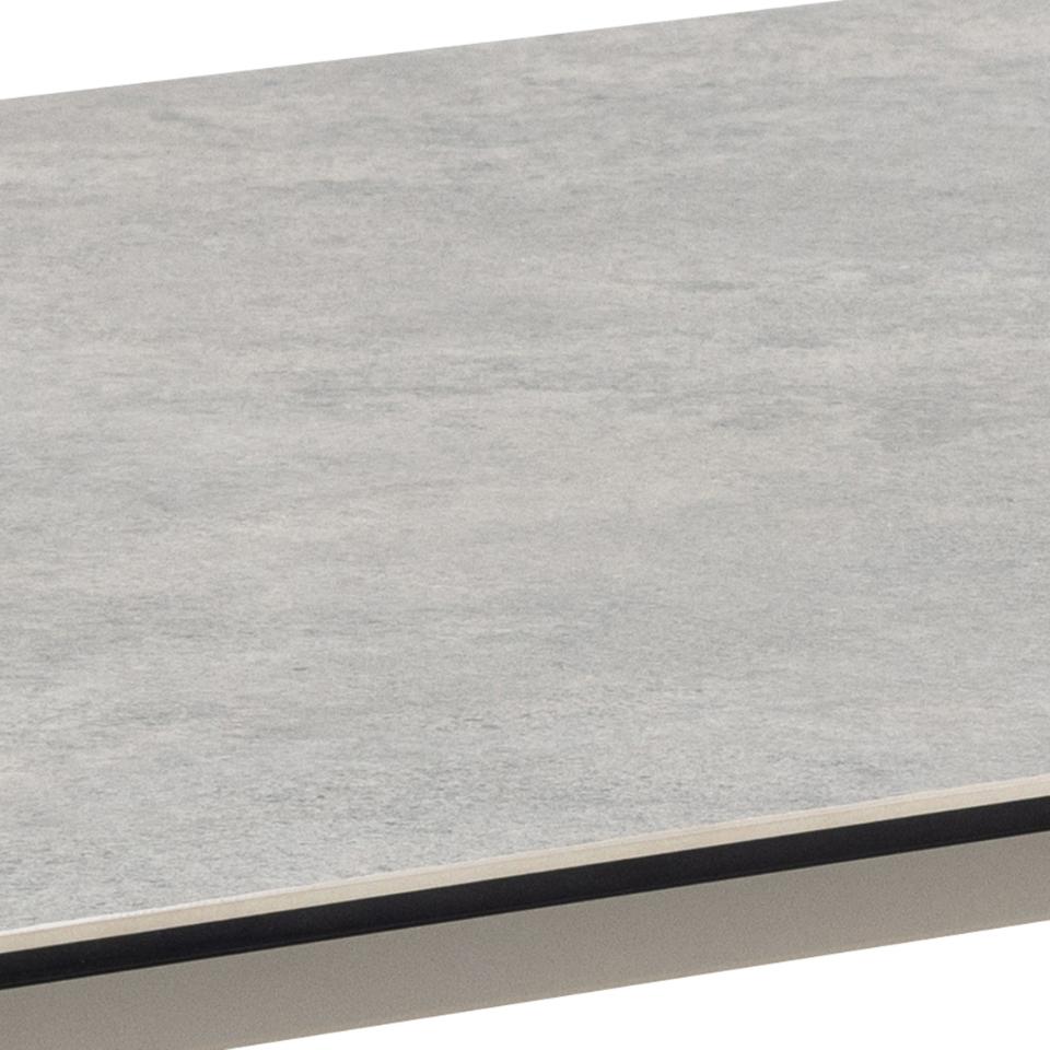 A close-up of a light grey ceramic surface with a thin dark edge and a grey base, shown against a white background.