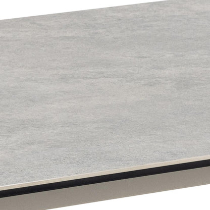 A close-up of a light grey ceramic surface with a thin dark edge and a grey base, shown against a white background.