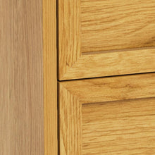 Load image into Gallery viewer, Close-up of a light oak wood cabinet door showing the grain texture and a raised panel frame.
