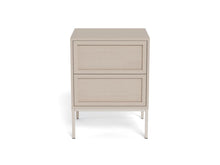 Load image into Gallery viewer, A modern two-drawer nightstand with a light beige wood-grain finish and slim silver metal legs, shown against a plain white background.
