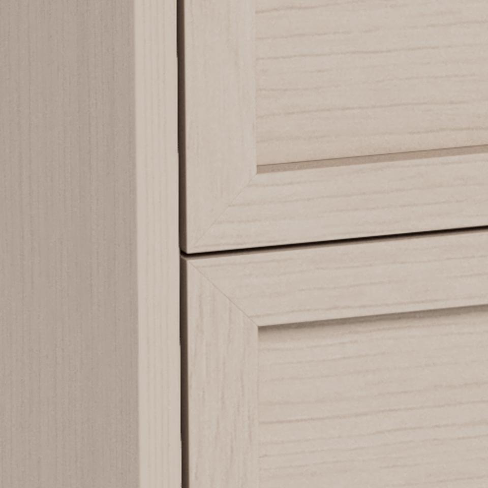 Close-up of a light beige wood cabinet or drawer front with a visible grain texture and a horizontal seam.