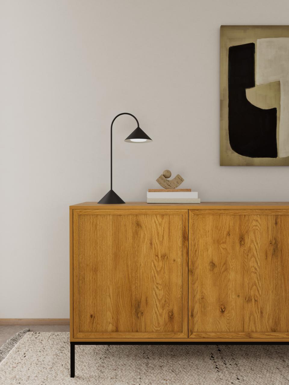 A mid-century look modern wooden Palmdale sideboard cabinet with a black metal lamp and books on top, set against a neutral wall with abstract wall art.