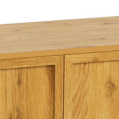 Close-up of a light oak wood sideboard with two paneled doors and a matching wood top surface against a white background.