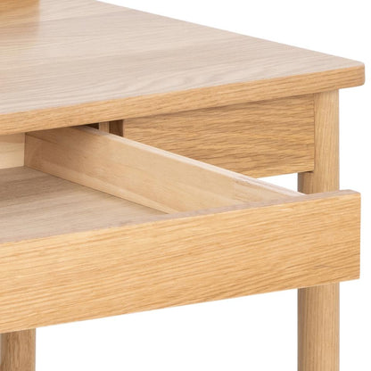 Close-up of a light oak wood table or desk drawer with the front pull handle extended outward, showing the natural wood grain and clean white background.