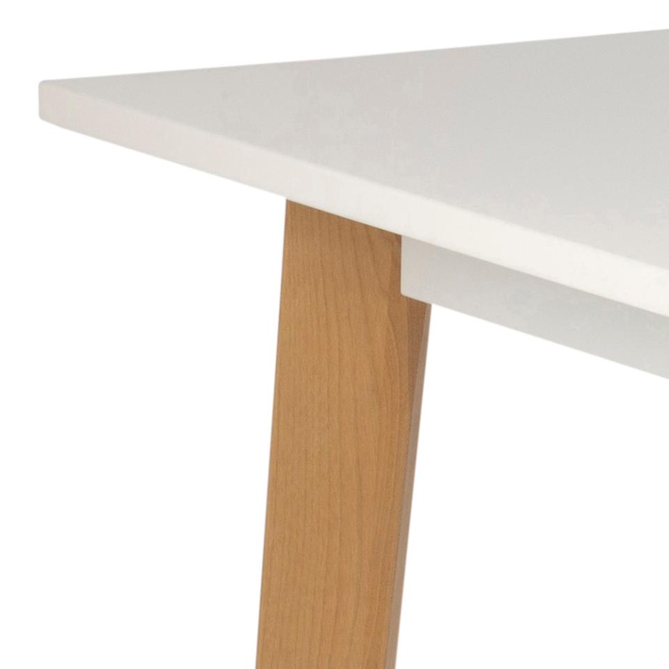 Close-up of a table with a white top and wooden leg on a white background