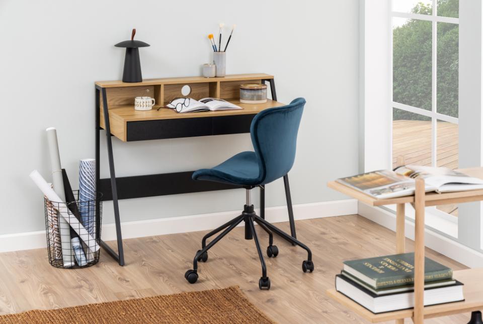 Modern home office with a desk, chair, and books in a well-lit room.