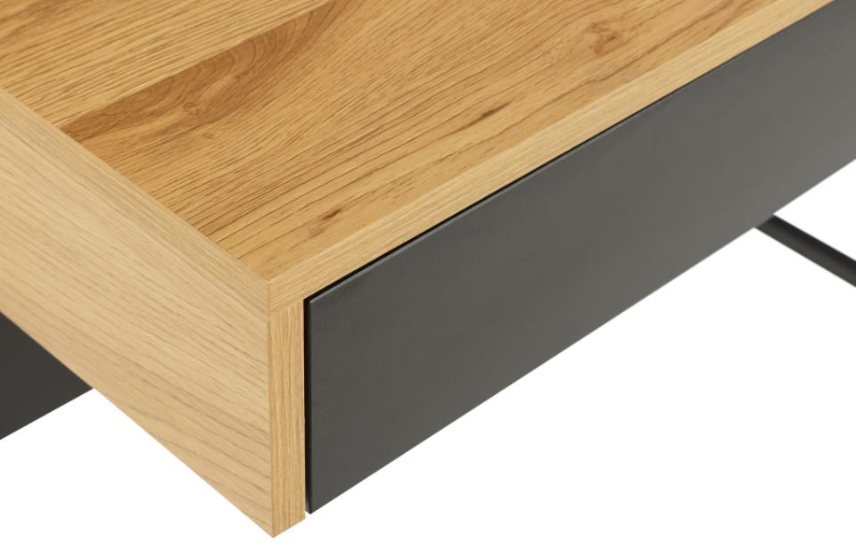 Close-up of a wooden desk corner with black metal frame