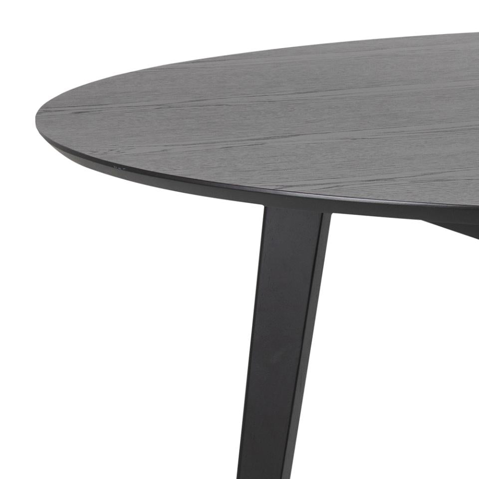 Round dark gray table with black legs on a white background