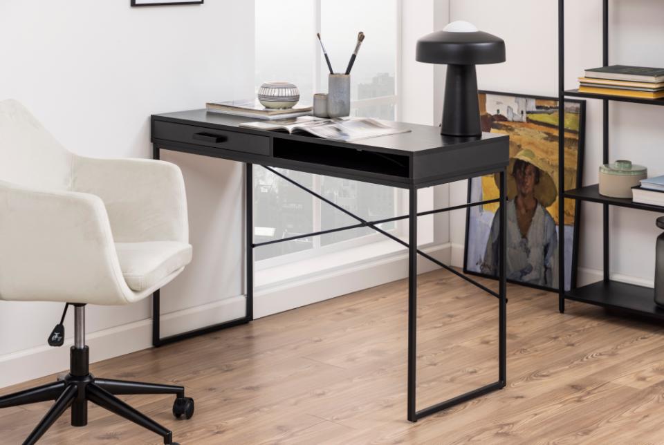 Modern office desk with a chair in a well-lit room