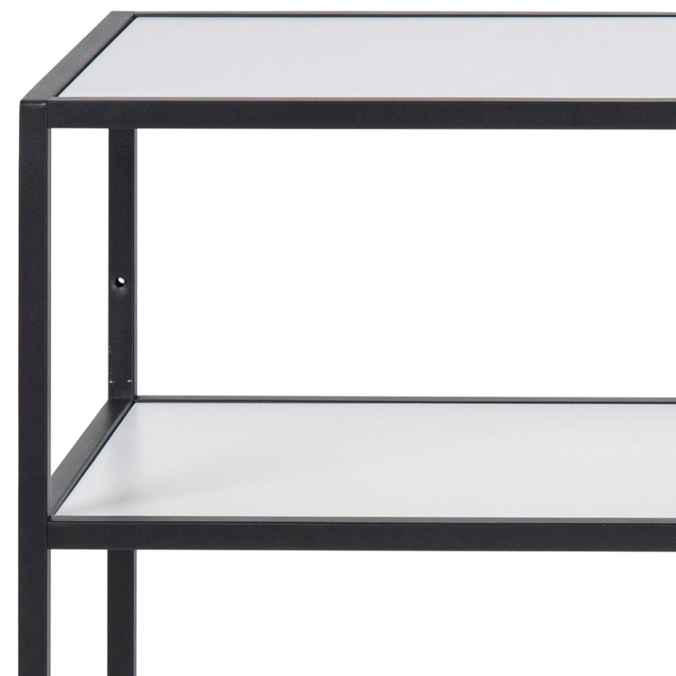 Close-up of a white metal shelving unit with white shelves, showing the corner frame and one shelf level against a white background.