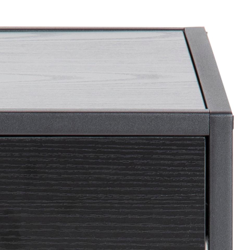 Close-up of a black outdoor furniture piece with a textured surface.