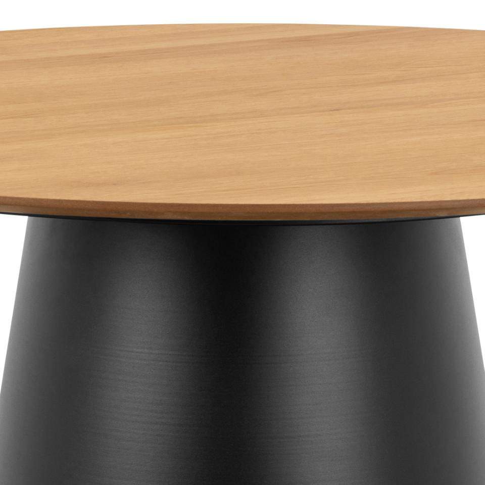 Close-up of a round table showing a light natural wood tabletop and a matte black tapered pedestal base against a white background.