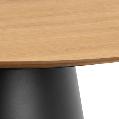 Close-up of a wooden table top with a black metal base