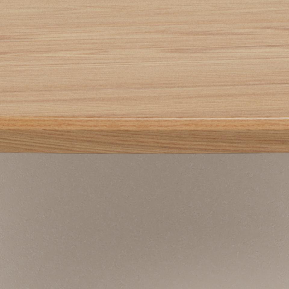 Close-up of a light natural wood tabletop surface with a smooth beveled edge, shown against a warm beige background.