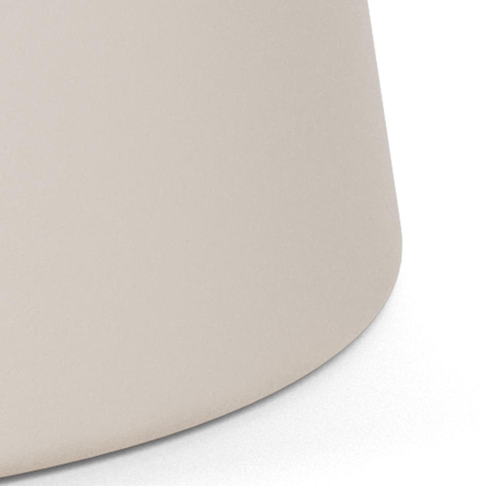 Close-up of a smooth, matte grey curved metal surface of a Soli dining table base against a clean white background.
