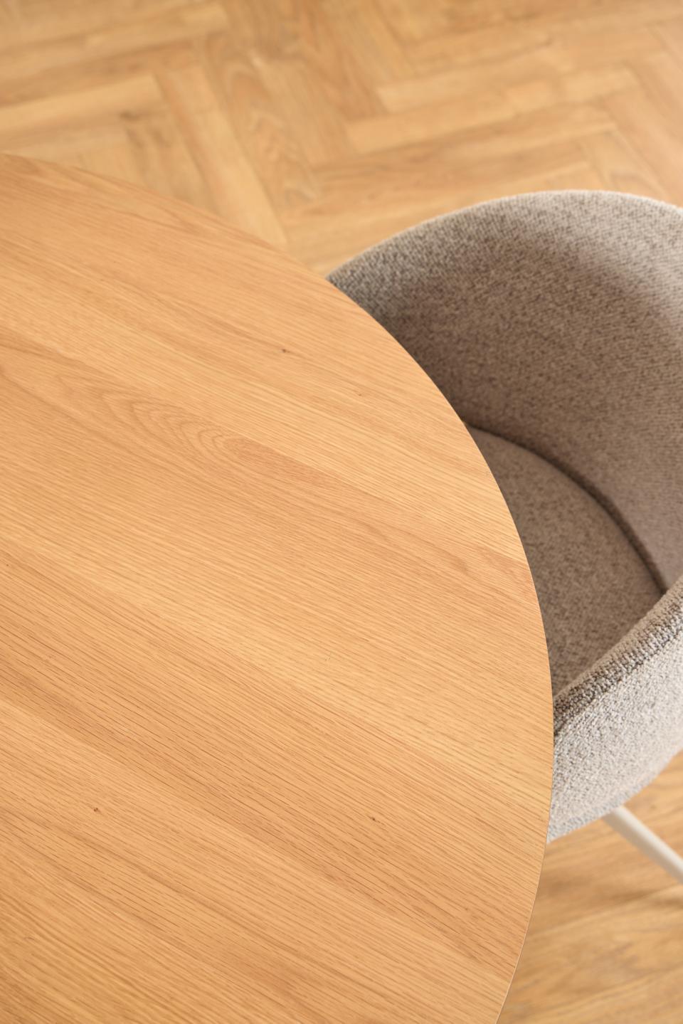 Wooden table corner with a chair on a wooden floor