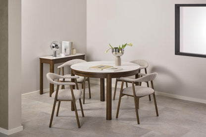 Dining area with a round Southampton dining table and four chairs in a modern interior setting.