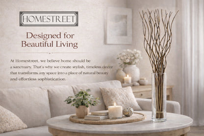 A styled living room scene with a beige sofa, round marble coffee table, candles, books, and a tall glass vase holding dried branches. Text on the left reads 'HOMESTREET' and 'Designed for Beautiful Living' with additional brand copy about creating stylish, timeless decor.