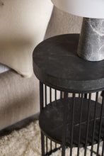 Load image into Gallery viewer, Black metal side table with marble-like top next to a sofa
