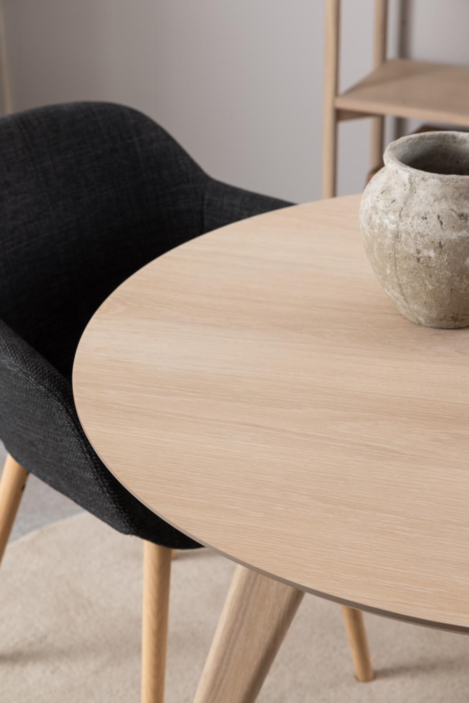 corner of the 100cm Townsville oak dining table with a pot on top next to a chair on a rug in a home