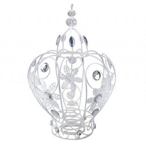 A white metal decorative tree topper ornament shaped like a heart, featuring intricate filigree cutouts of flowers and leaves, adorned with clear rhinestones, set against a plain white background.