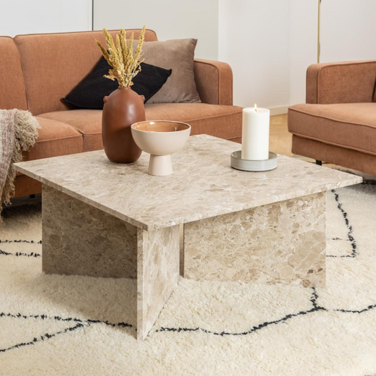 Modern living room with brown sofas, marble coffee table, and decorative elements.
