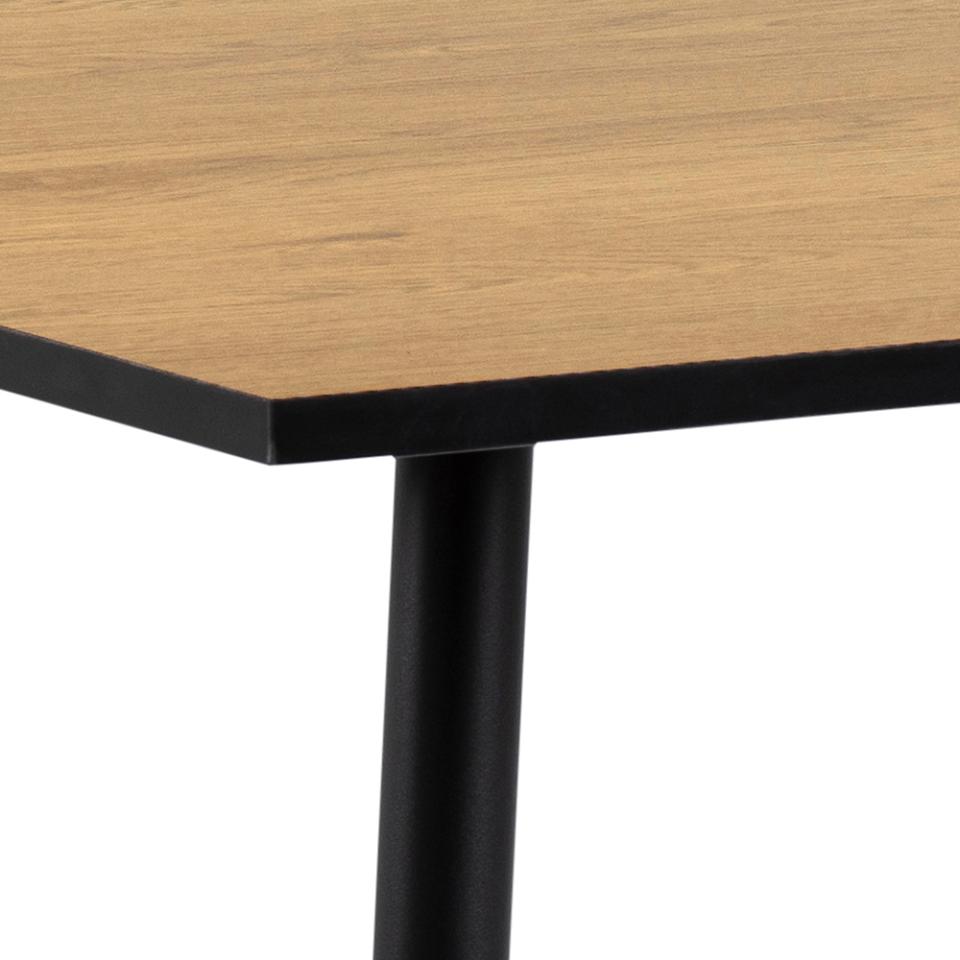 Close-up of a table corner showing a light oak wood tabletop with a black metal edge and a black metal leg on a white background.