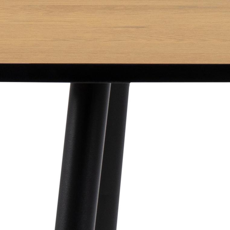Close-up of a wooden table with black metal legs on a white background