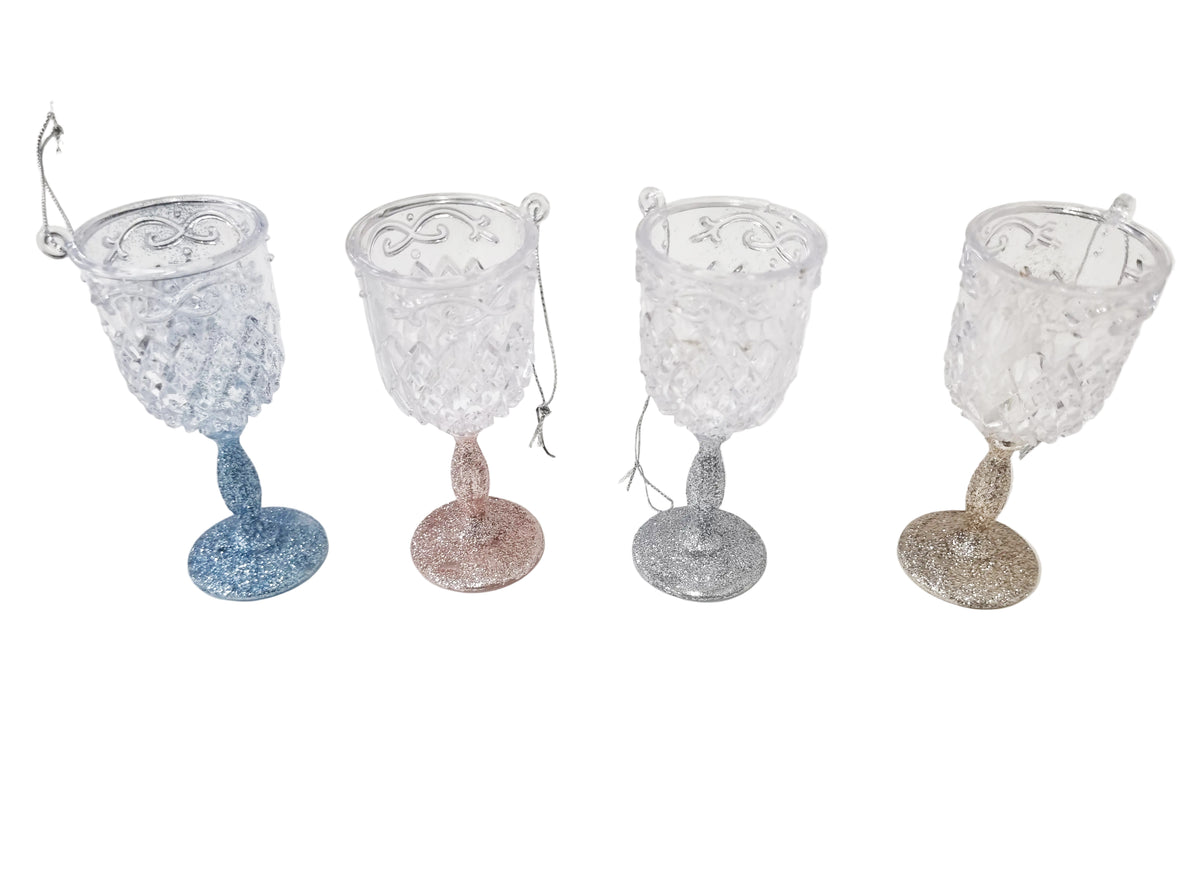 Four decorative crystal goblet ornaments with glittery bases in blue, rose gold, silver, and gold, displayed on a white background.
