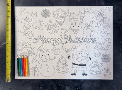 a colour your own placemat with pencils on top next to a a tape measure in yellow showing the height of the placemat to be 30cm