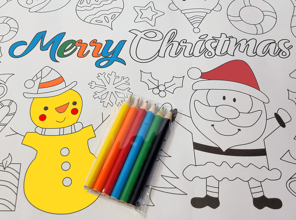 a close up of colouring pencils in various colours on a colour your own placemat featuring a snowman and santa