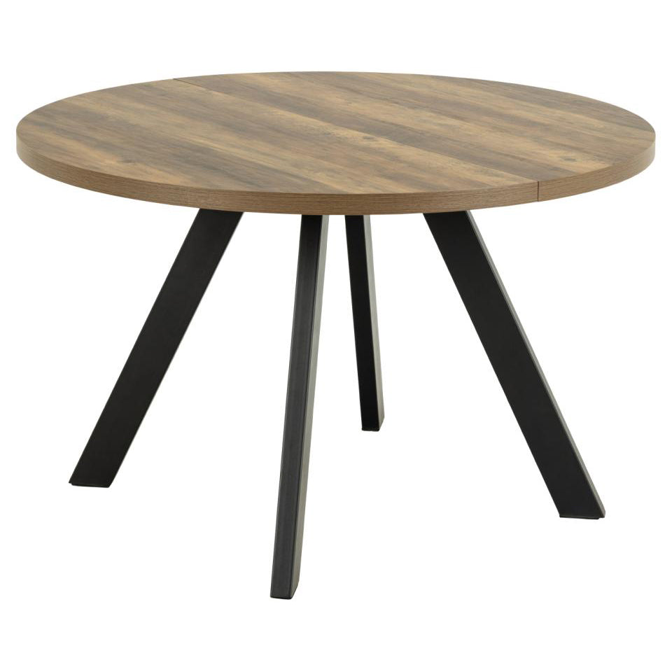 Round dining table with a medium brown wood-grain top and four black angled metal legs, shown on a plain white background.